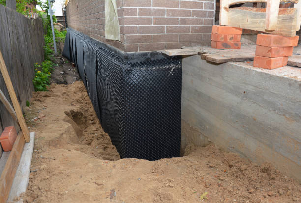 Happy homeowners after waterproofing job in North Newton